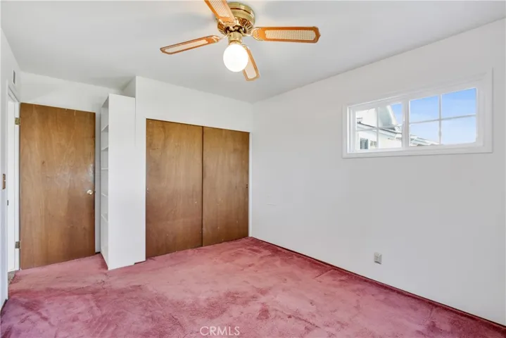 Third bedroom with built in bookshelf