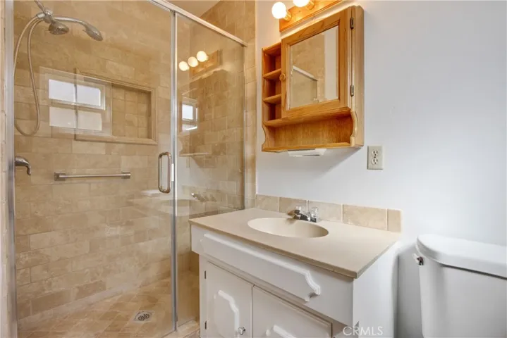 Private Bathroom off the Primary Bedroom with Stone Shower, and newly installed flooring