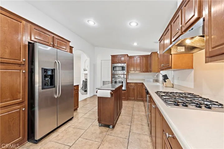 Large kitchen with stainless steel appliances.