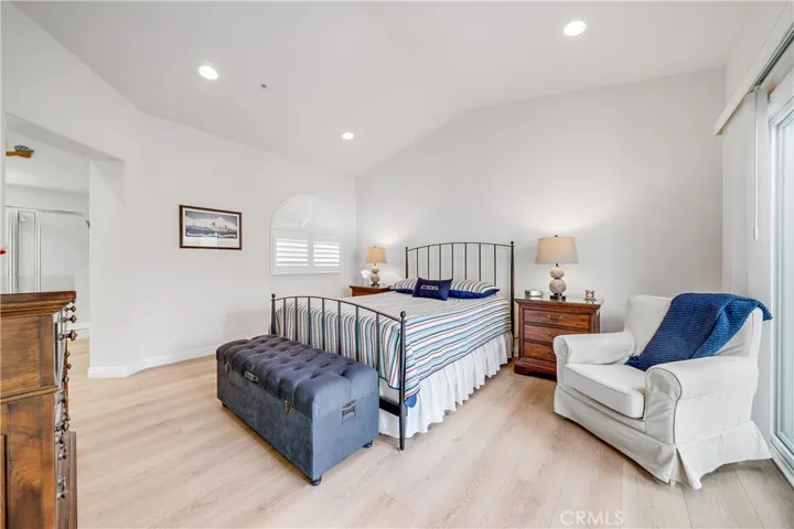 Spacious primary bedroom with high ceilings & recessed lighting