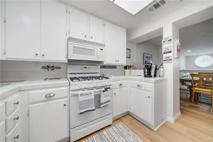 Kitchen offers newly painted cabinetry ad new stove