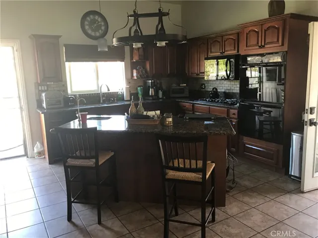 Spacious kitchen with island and vegetable sink
