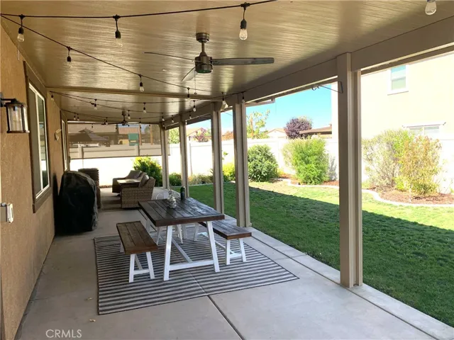 Covered Patio with ceiling fans and sunshade