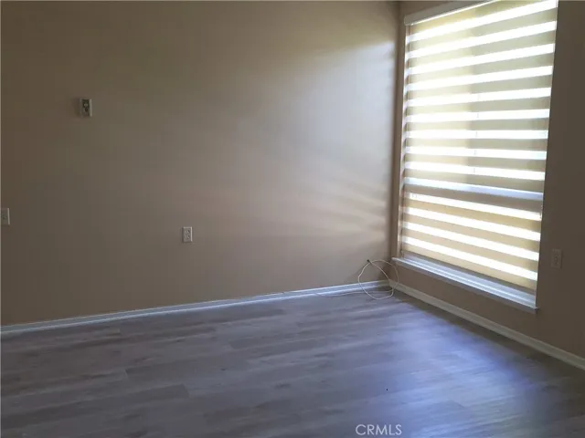 Master bedroom window covered with blind.