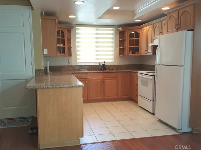 Remodeled kitchen with granite counter tops, and smooth cook top oven.