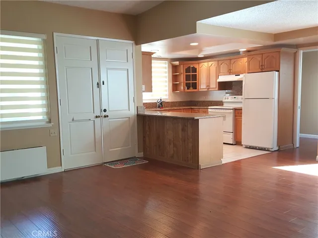 Open kitchen from the living room view with double entry door.