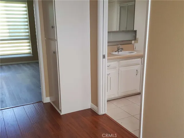Hallway to master bedroom on left, and bathroom entry on the right.