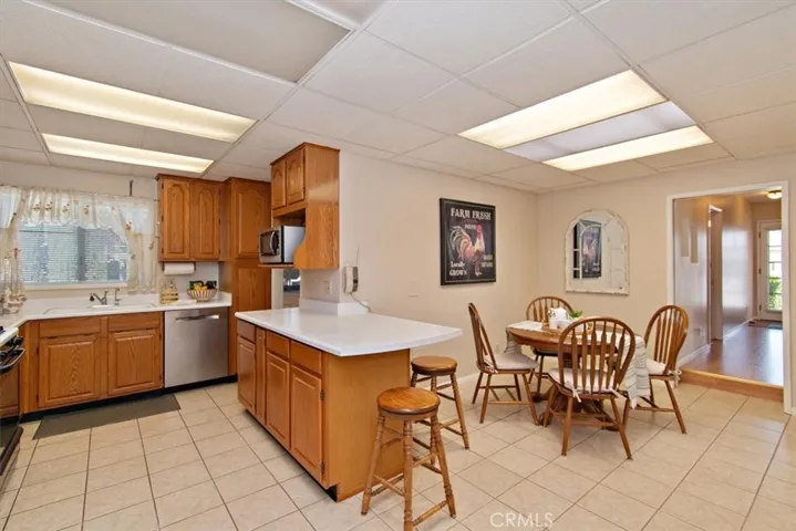 Kitchen with oak cabinetry that opens to breakfast room