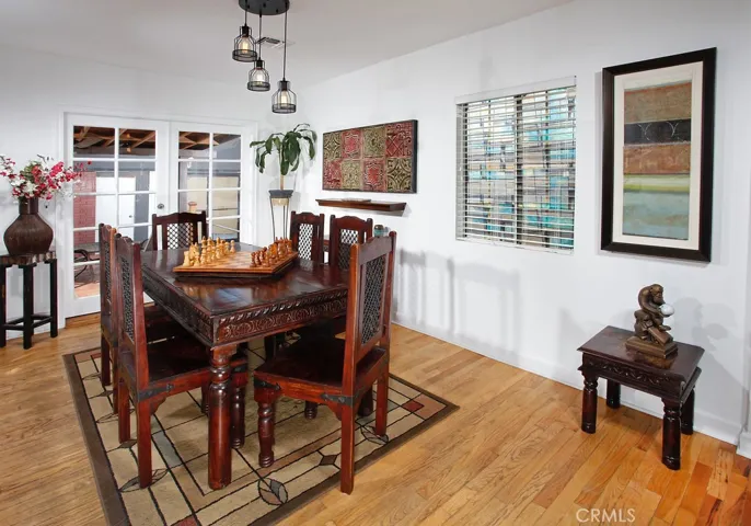 The dining room with its elegant French doors, sparkling picture windows, modern drop-down lighting and original hardwood floors is perfect for any occasion.