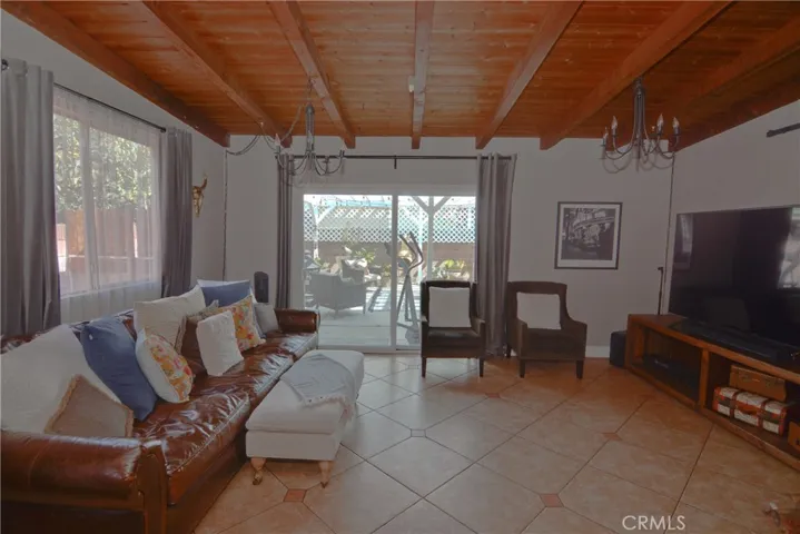 Step down living room with sliders leading to back yard covered patio