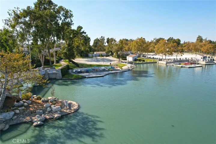 Another photo of the South Lake, lagoon, boats and dock, as well as a sand volleyball court.