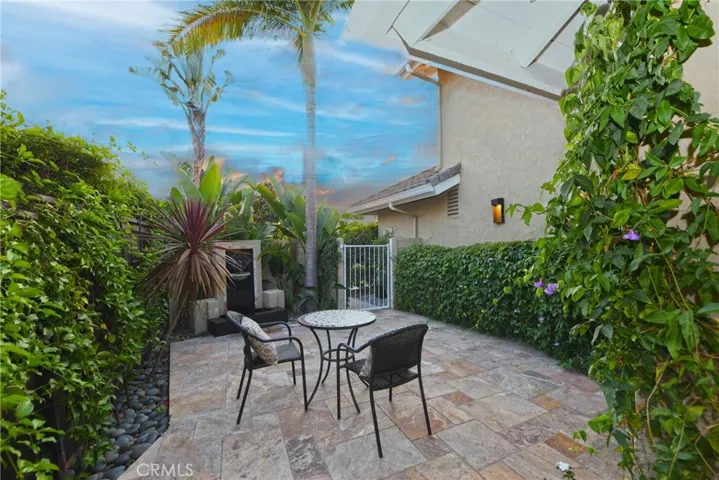 you'll find a welcoming patio and tranquil water feature.