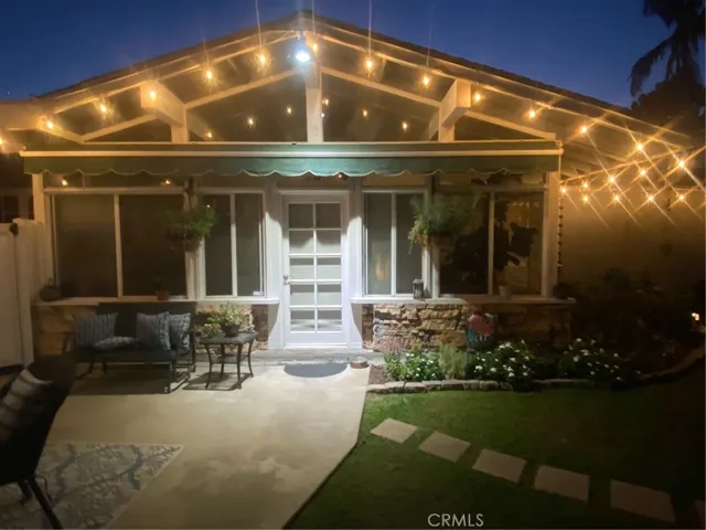 Evening view of the backyard entry to the sunroom.