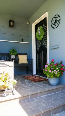 Front porch has security cameras, a ring bell, and a locking package box.