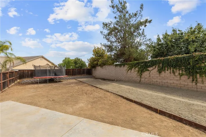 View of side yard.  There is running water to auto fill a pool and electricity.