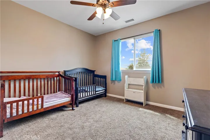 Bedroom with ceiling fan, large enough for a king size bed.