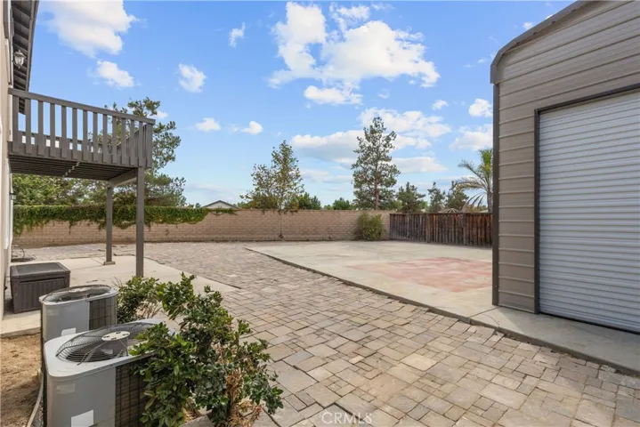 View of Master bedroom balcony and large backyard.