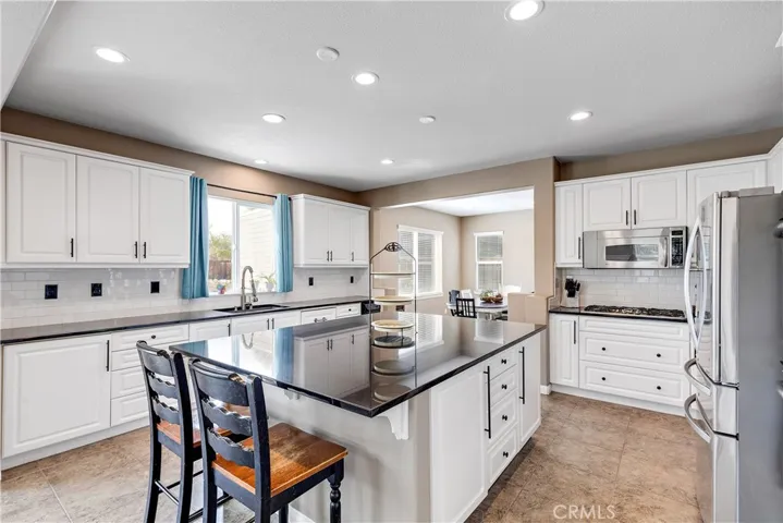 Dream Farmhouse kitchen with an approximate 5'x7' black granite center island.  The dining nook is spacious for a large farmhouse table.
