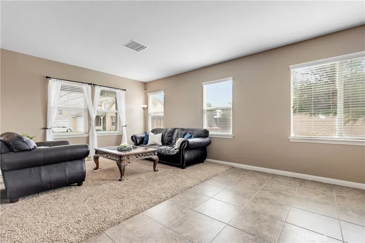 Living room, tile area can be used as formal dining room or down stairs play area for small children.