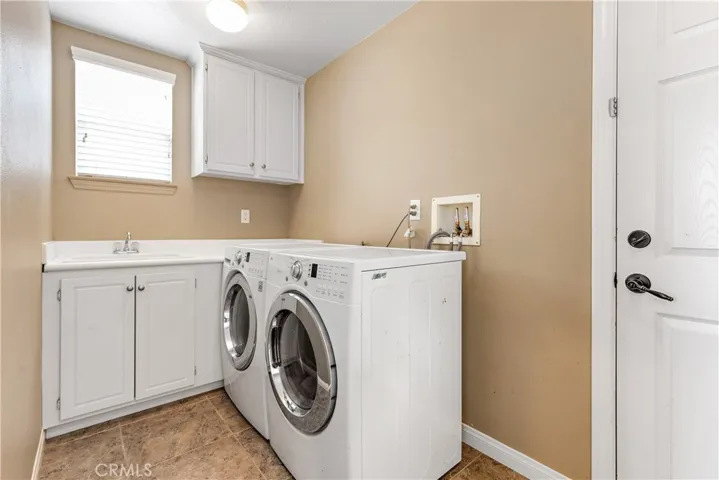 Laundry room is adjacent to 4 car garage.
