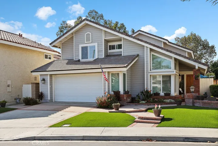 This home is ideally situated on a cul de sac street and has beautiful curb appeal with artificial grass and lovely plants.