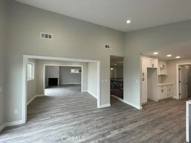 GRAND KITCHEN AREA LOOKING INTO FORMAL DINING AREA AND ON TO LIVING/FAMILY ROOM