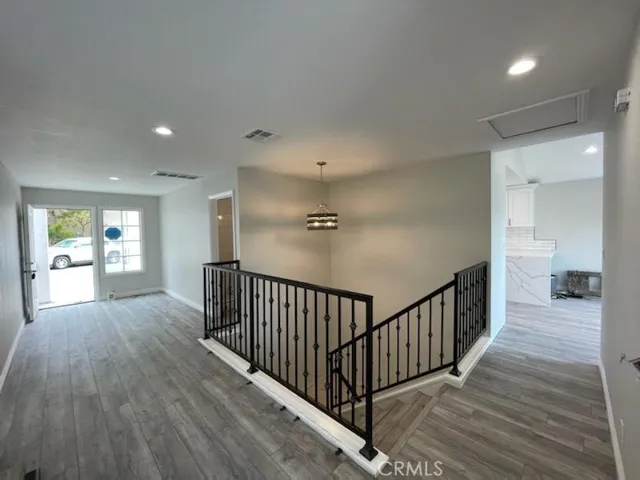 LOOKING OUT TO FRONT ENTRANCE (LEFT) & KITCHEN (RIGHT)