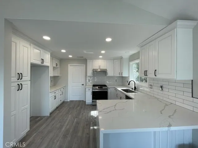 VIEW OF KITCHEN LOOKING AT GARAGE DOOR, TO THE RIGHT OF GARAGE DOOR IS LAUNDRY ROOM