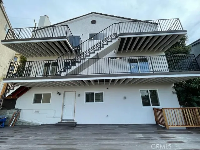 BACK VIEW OF HOME STANDING ON THE DECK
