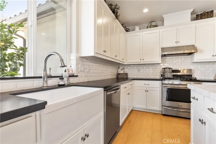 Leathered black granite counter with subway backsplash