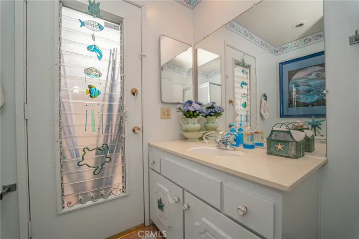 Bathroom adjacent to family room outside access from side yard