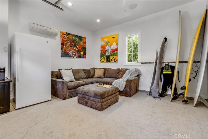 Inside of the 5th garage.  Currently using as kids gaming room with TV and individual HVAC system.