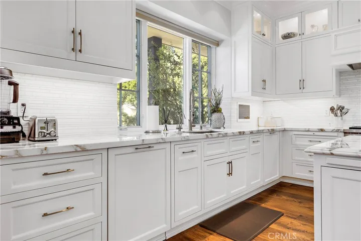 Calcutta marble counters, stainless steel farmer sink.  Double dishwashers.