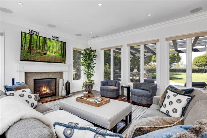 Family room is open to the yard.  Hunter Douglas automatic blinds.