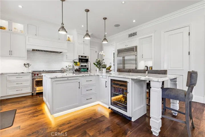 Large center island with lots of seating and wine & beverage fridge.  Utility sink in the island.