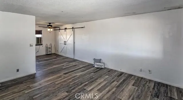 Spacious living room with dining room attached - barn doors open up to bonus family room