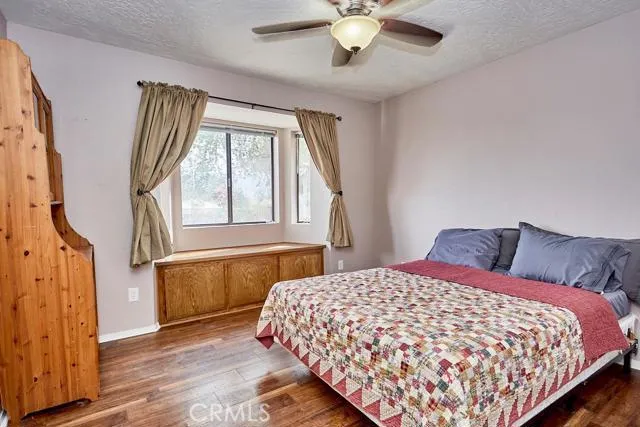 Large bedroom with seated bay window nook.