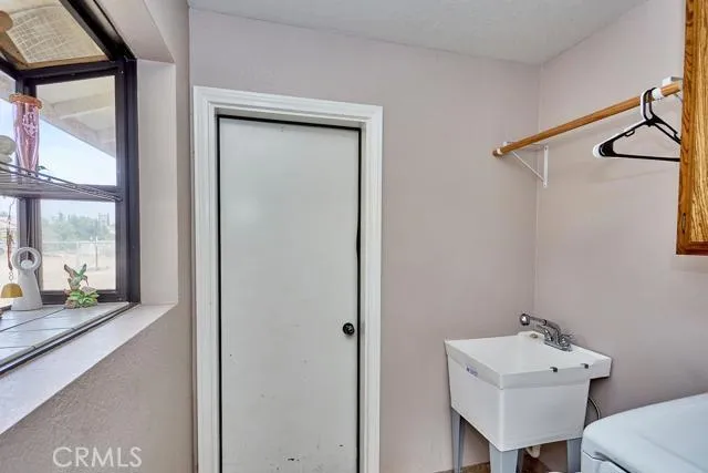 Spacious indoor laundry room with garden window for precious houseplants, Spring seedling starts, and display.