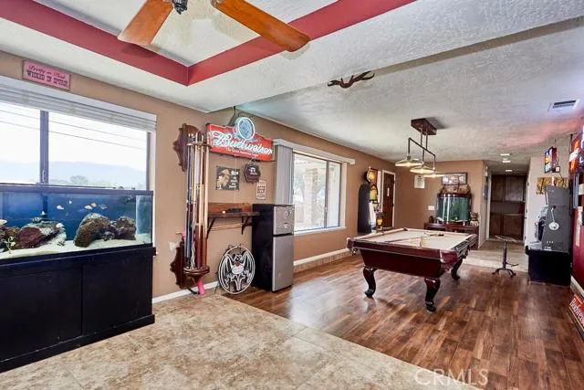 Game room with upgraded flooring adjacent to the formal dining room that is currently used as a bar area.