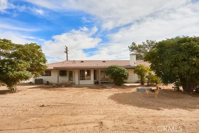 Rear of home features double patio spaces off the living room and laundry room.