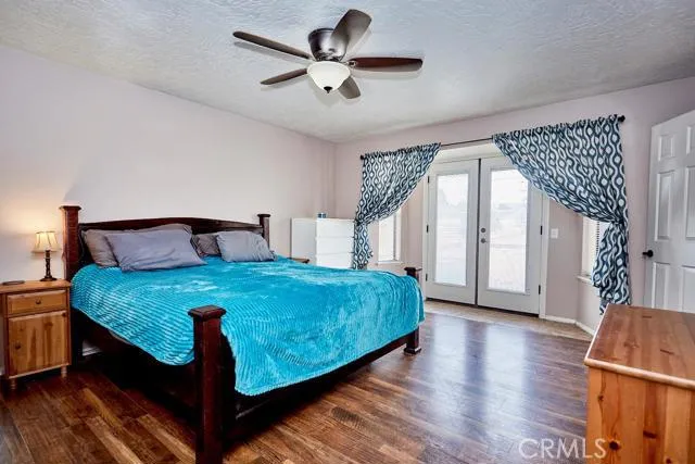 Large master bedroom fits a full suite of furniture and has double French doors to the back patio.