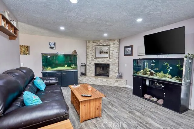Gorgeous upgrades completed on the inside of this property. See stacked stone design around fireplace and across hearth and upgraded flooring. The living room has can lights.