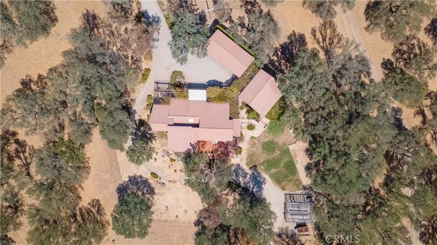 Aerial view of the main home, annex (right) and the covered parking (north)
