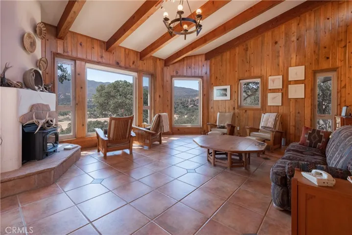Light and open living room with magnificent views of the pond and rock outcroppings