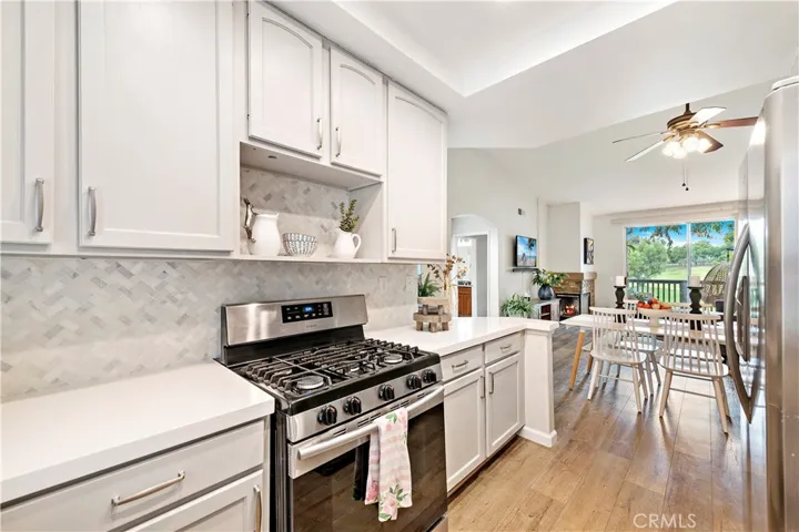 Recently updated kitchen with quartz counters and marble backsplash.