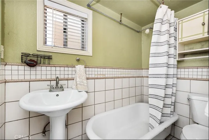 FULL BATHROOM LOCATED OFF OF GARAGE IN THE OUTBUILIDING