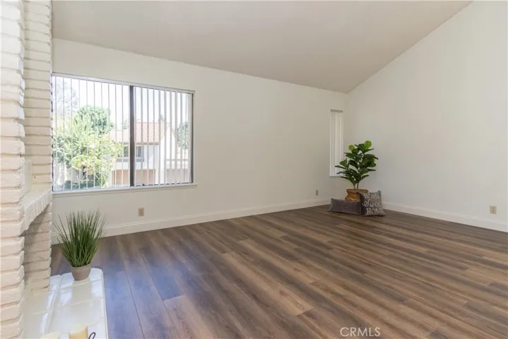 Huge living room has vaulted ceiling.