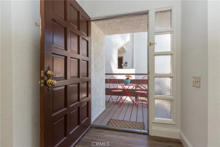 Grand entry door with side lights and large deck.