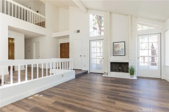 Volume ceiling and smooth wood style floors.