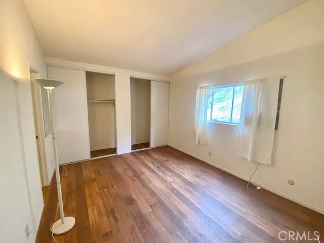 Master bedroom with wood look vinyl flooring.